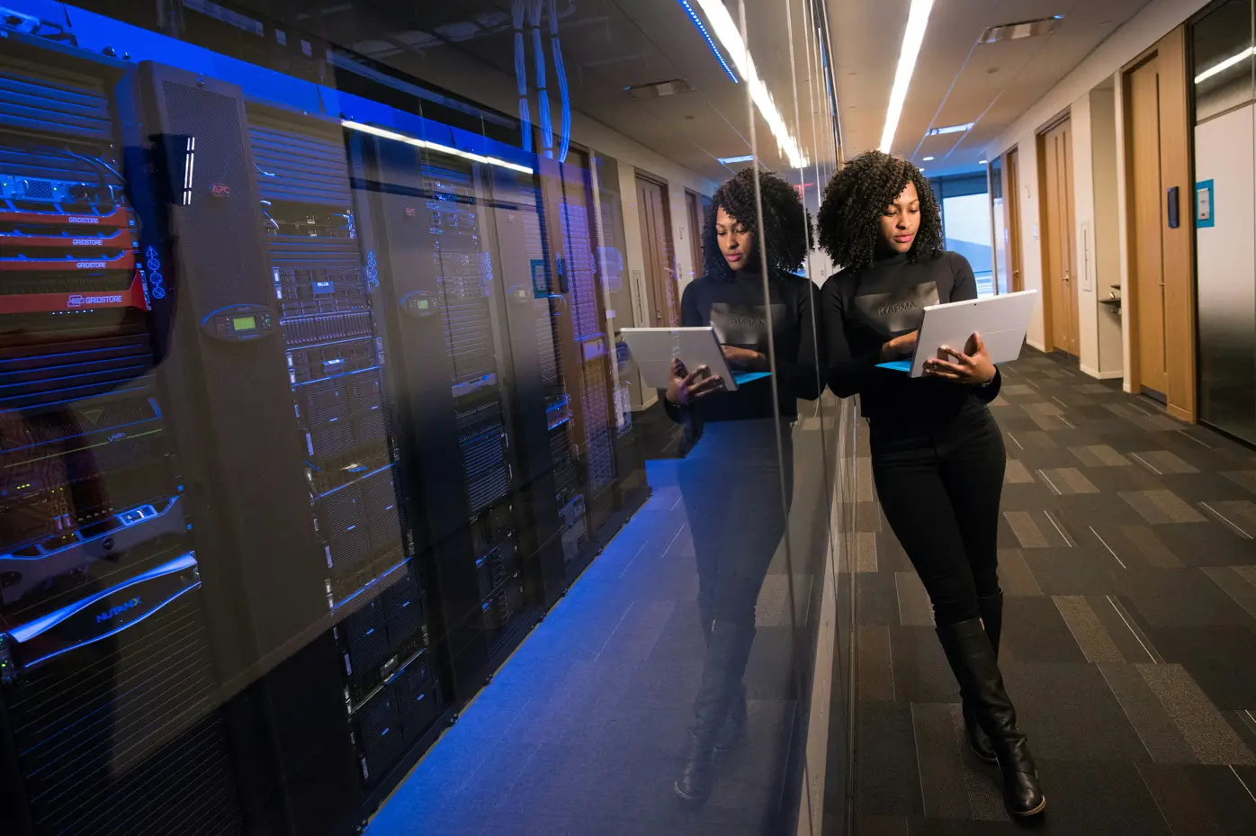 A female standing inside a data center