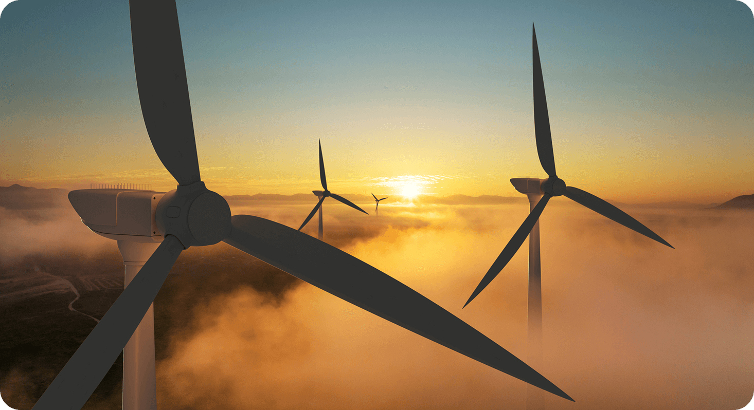 Three large wind turbines above low level clouds