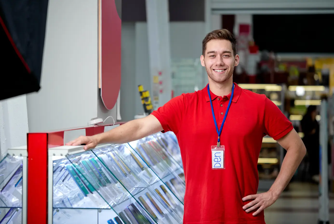 An EZ Pawn employee wearing a red shirt