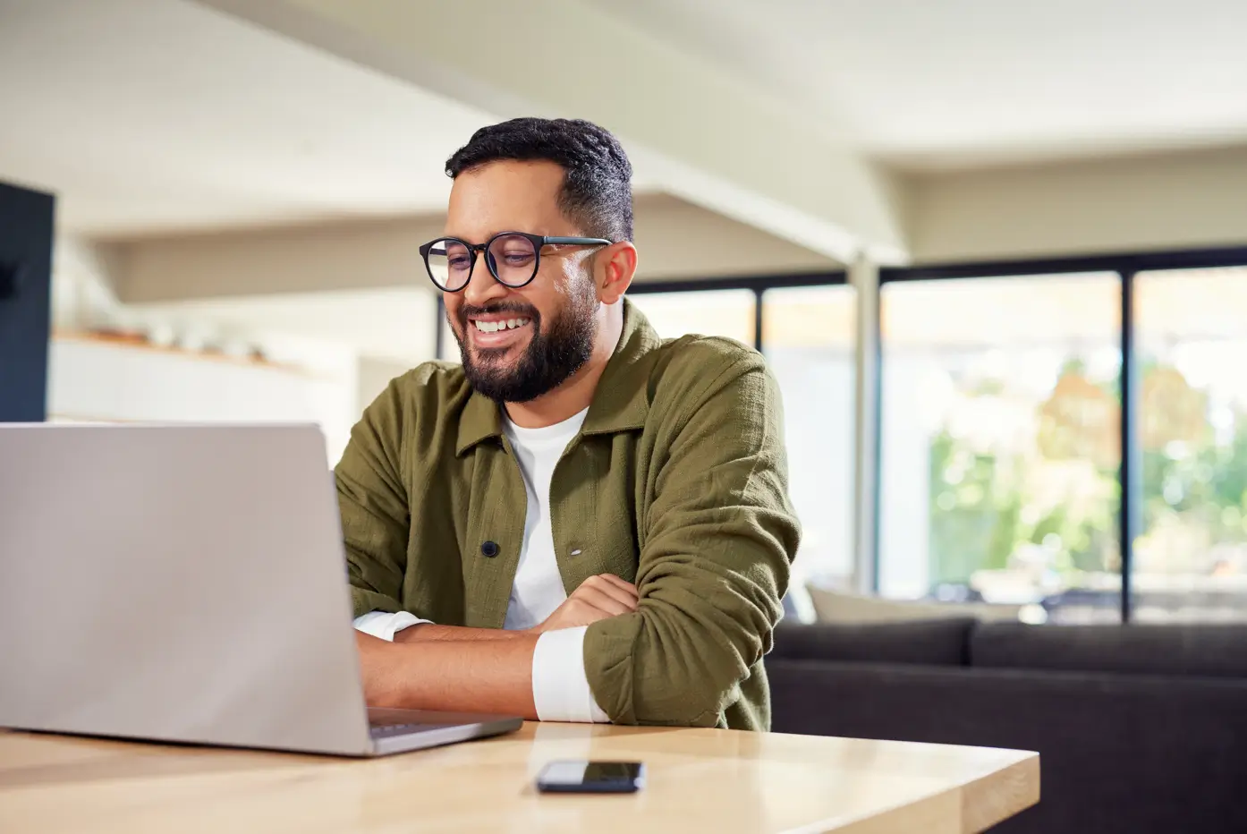 A male viewing a webinar on his laptop